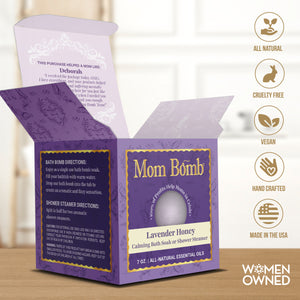 Close-up of Lavender Honey Bath Bomb in open packaging showing directions and women-owned certifications.
