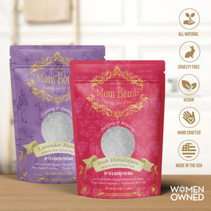 Two 3-pound bags of Mom Bomb Lavender Honey and Pink Himalayan bath salts on a wooden counter with clean beauty icons and WOMEN OWNED badge