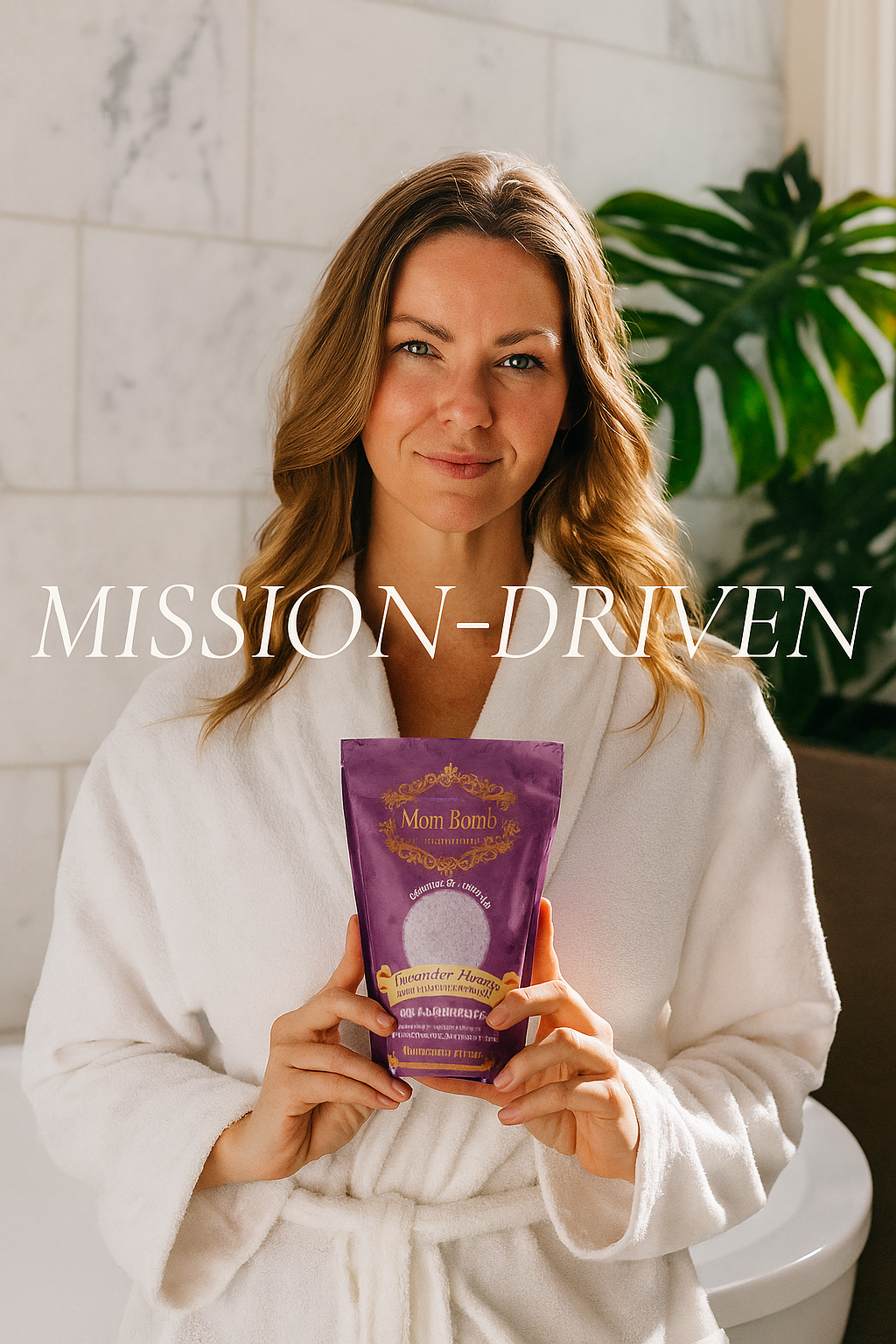 Woman in white bathrobe holding a purple Mom Bomb bath soak pouch, standing in a bright bathroom with green plant in background. Text overlay reads “MISSION-DRIVEN.”