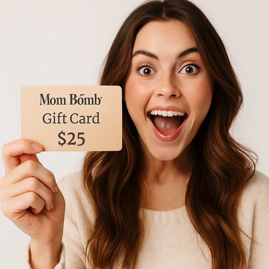 Excited woman holding a Mom Bomb gift card toward the camera, featuring the Mom Bomb logo, the words 'Gift Card', and '$25' in elegant text on the card
